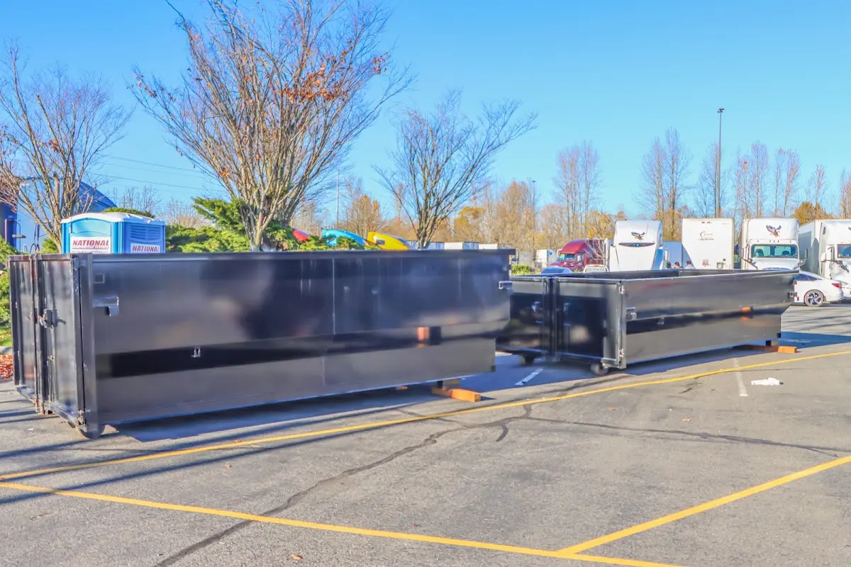 Professional dumpster rental service with roll-off container on residential driveway in Jennings